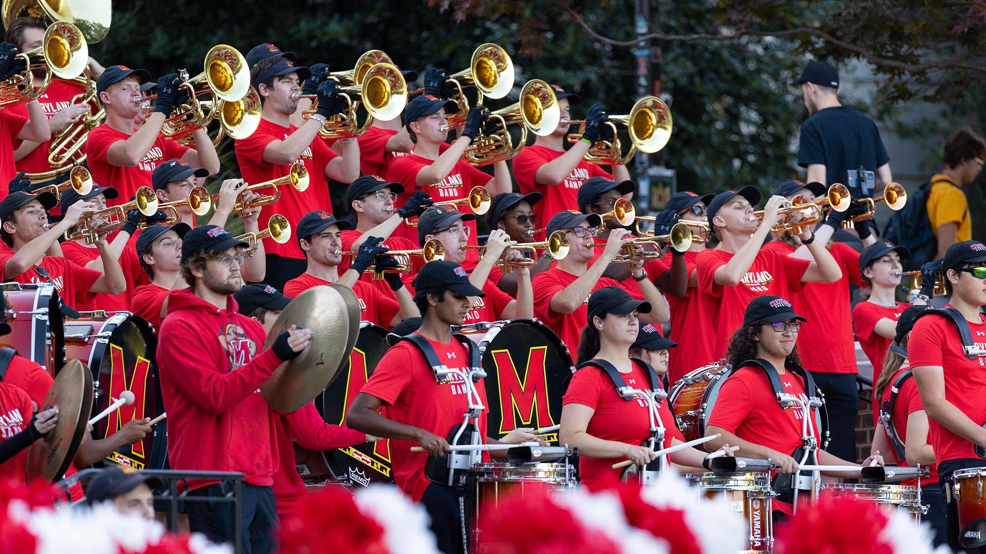 band playing in the stands. Trumpets and drums
