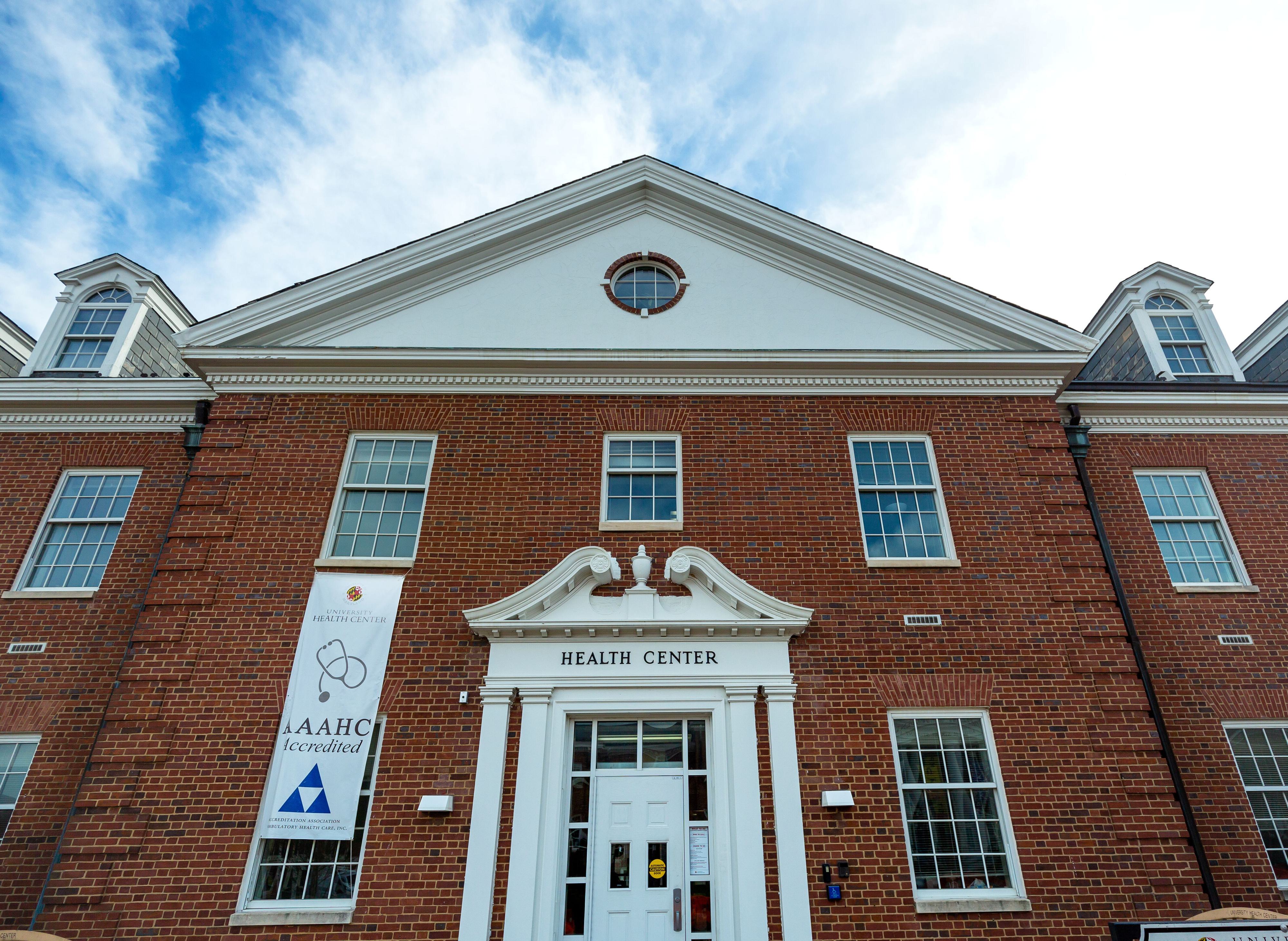 A brick building with white trim and letters over the door that read "Health Center"