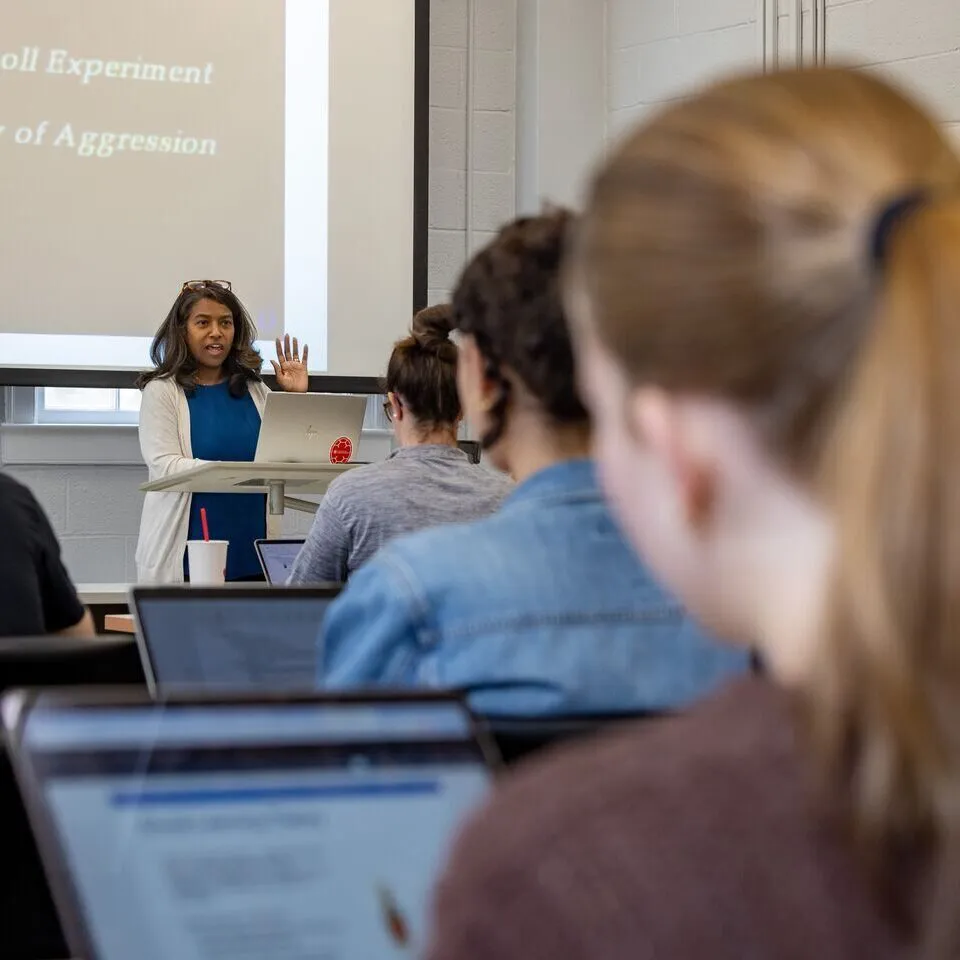 Professor in class, students from the back of the class