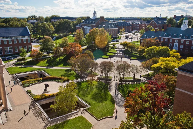 Aerial view of campus, showing hardscaped plazas with trees and traditional building