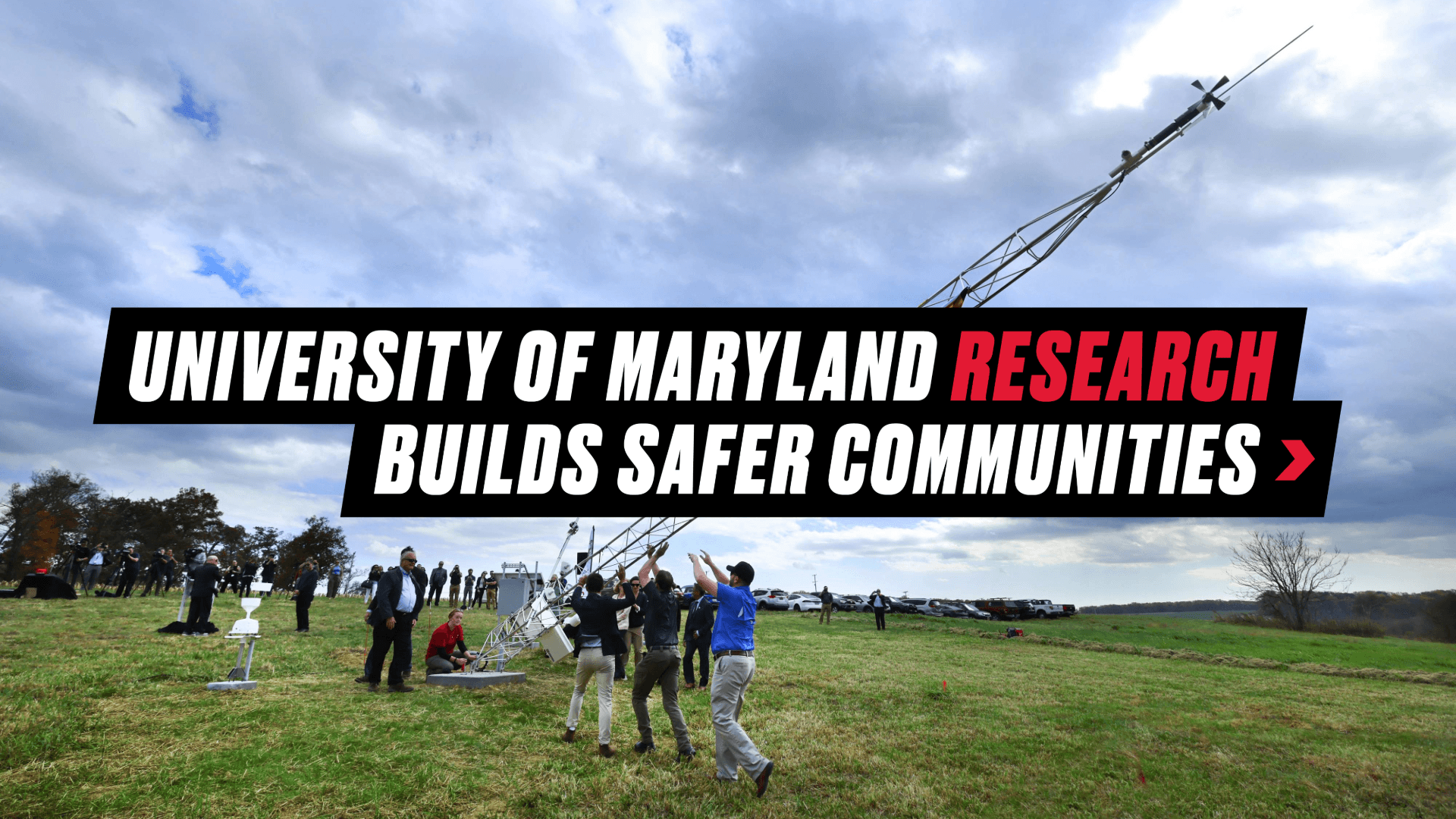 Graphic reading "University of Maryland Research Builds Safer Communities" over a background image of researchers lifting the first Maryland Mesonet to install it
