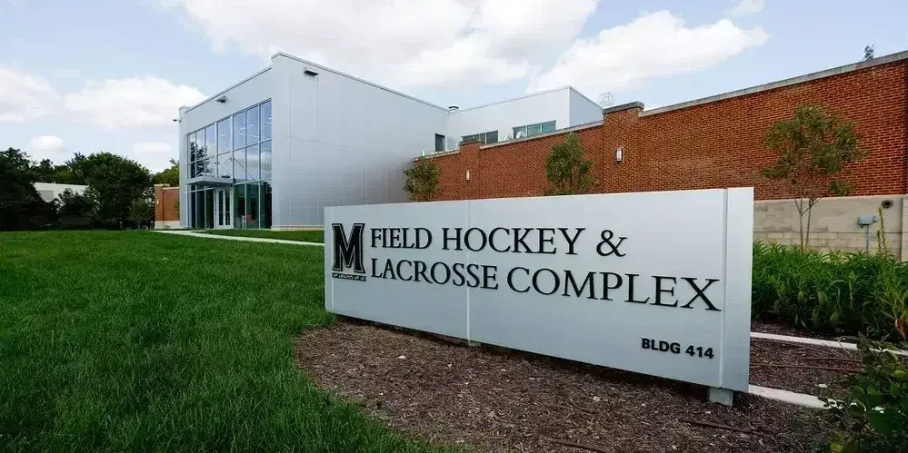 Outside of building. Sign: Field Hockey & Lacrosse complex, BLDG 414