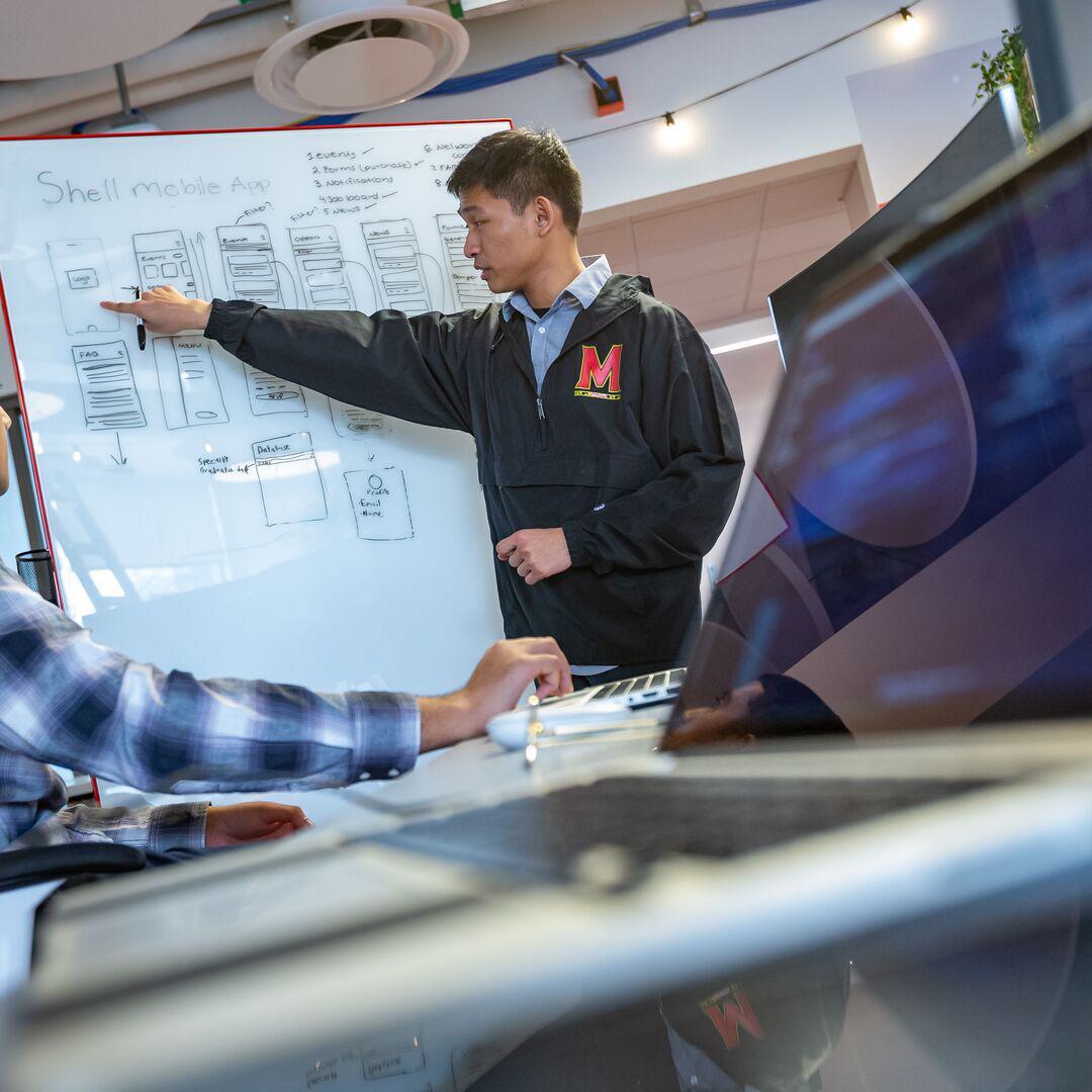 Professor pointing at chart