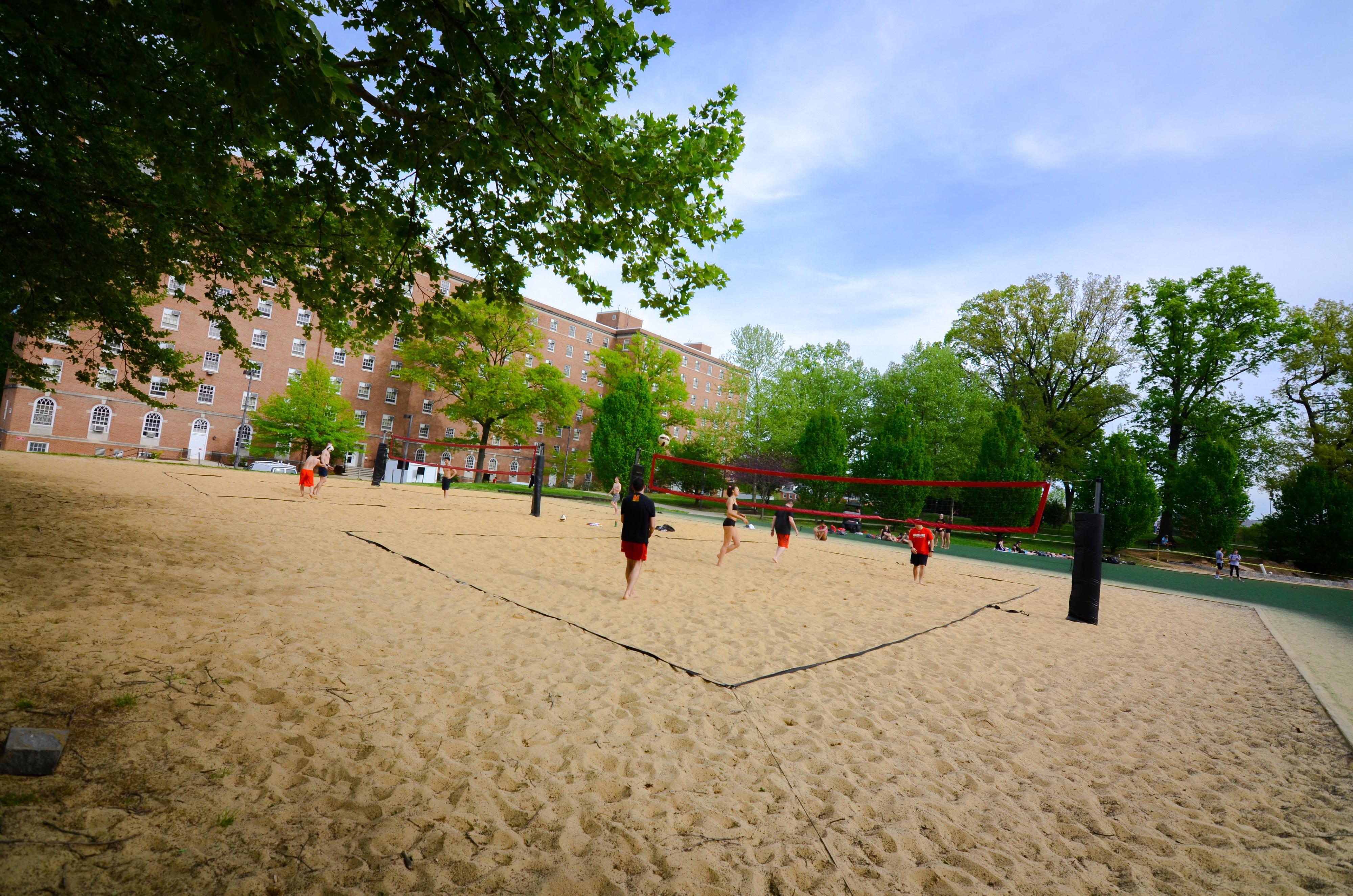 large outdoor sand area where students are playing sports