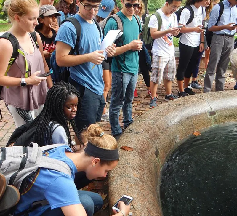 A group of students lined up around a body of water
