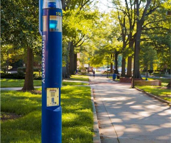 Blue Emergency Callbox along a sidewalk of the university campus
