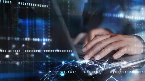 composited image with hands typing on keyboard and tech lights