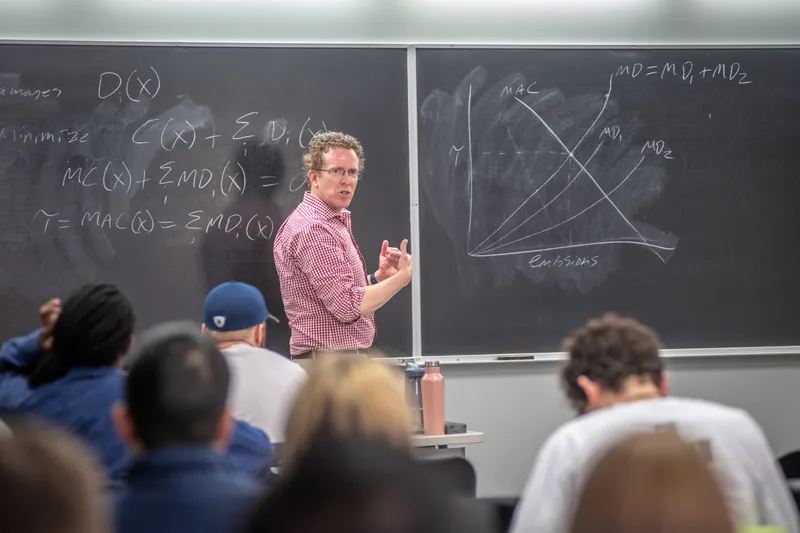 Professor at chalkboard in front of a class